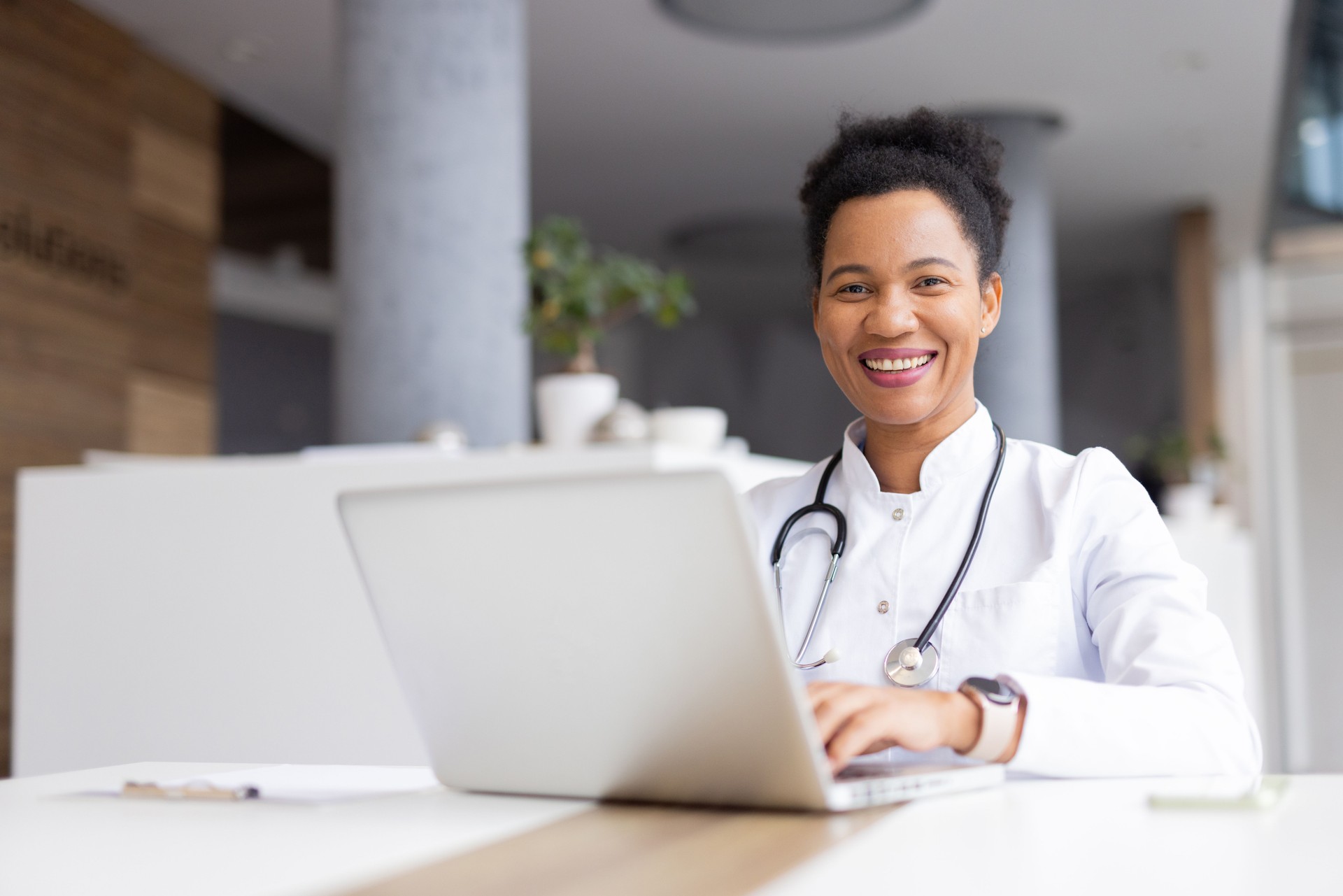 Experienced African American doctor reviewing lab results on a laptop