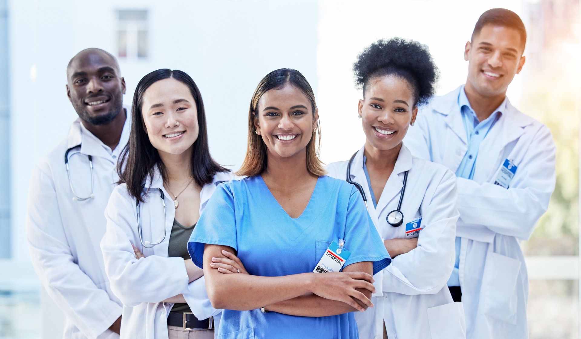Portrait, doctors and arms crossed with smile for teamwork, healthcare and hospital management. Group of happy medical employees, diversity and clinic collaboration of integrity, trust and about us