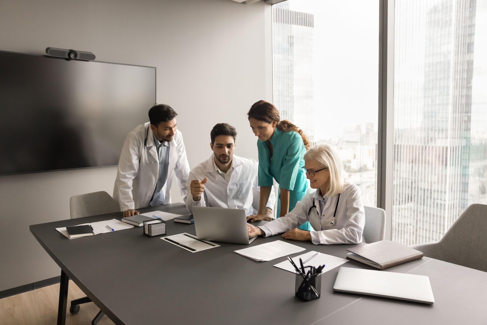 Team of medical colleagues using laptop for Internet communication